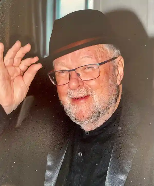 Portrait of author John Reynolds wearing a hat